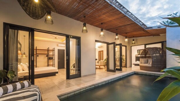 A modern home with a swimming pool, open-plan living spaces, and a cozy seating area. - Vibey, spacious 3-bedroom villa with WiFi, AC, Pool, in the heart of Canggu (Canggu, Kec.Kuta Utara, Kab. Badung)