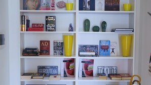 A bookshelf with various books and decorative items.