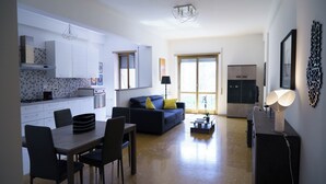 A modern apartment with a kitchen, dining area, and living room.