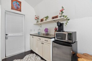 Fridge, microwave, coffee/tea maker, cookware/dishes/utensils