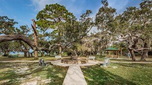 A park with a central stone fountain, benches, and a gazebo. - CRYSTAL BEACH GETAWAY-STEPS TO THE GULF (Crystal Beach)