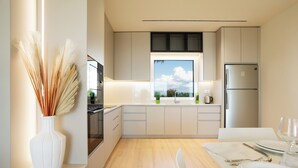 A modern kitchen with a wooden countertop, white cabinets, and a view of the outdoors through a window. - Villa Cosmo (Rrashbull)
