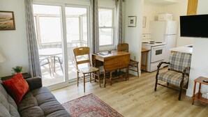 A compact living space with a dining area, kitchenette, and seating. - Gallant Cottage-PEI Charm, updated cottage with AC near Charlottetown. Waterview (Alexandra)