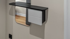 A wall-mounted shelf with a mirror and a drawer.