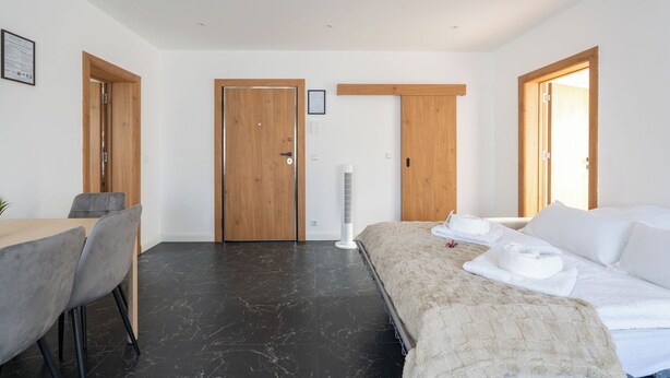 Een hotelkamer met een bed, een bureau en twee deuren.