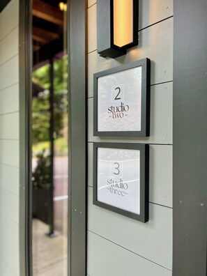 Two framed signs with numbers and text indicating 'Studio Two' and 'Studio Three'.