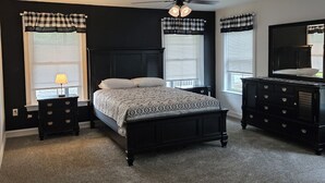 A bedroom with a bed, two nightstands, a dresser, and a ceiling fan. - Just Like Home, brand new 2 bedroom rancher with full kitchen. (Mohnton)