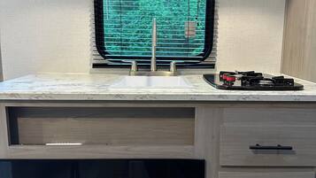 Fridge, microwave, stovetop, coffee/tea maker