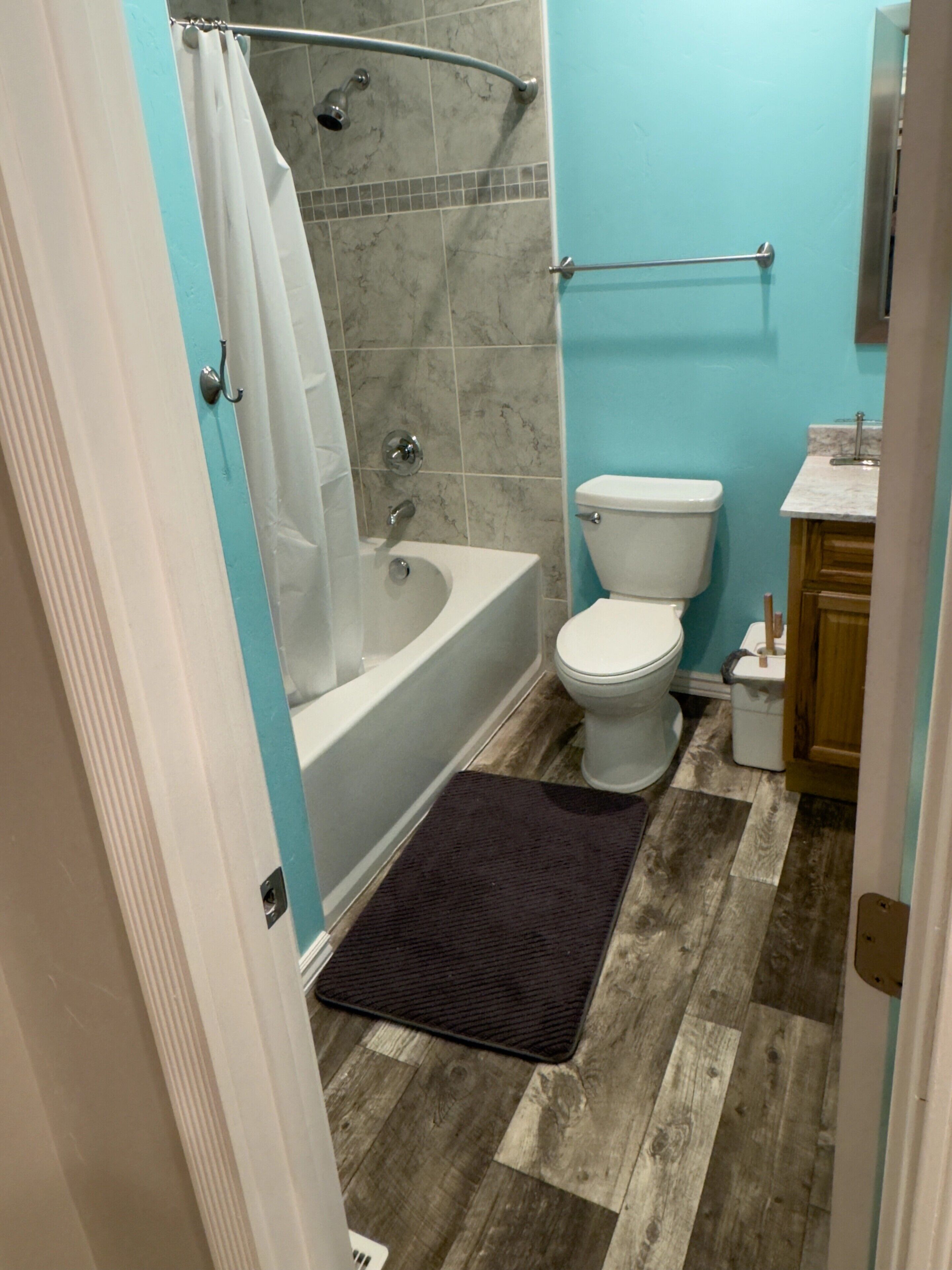 A bathroom with a bathtub, toilet, and sink.
