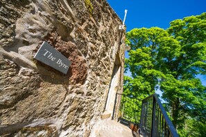 A stone wall with a plaque reading "The Bye." - The Byre, Countryside Home (Tough)