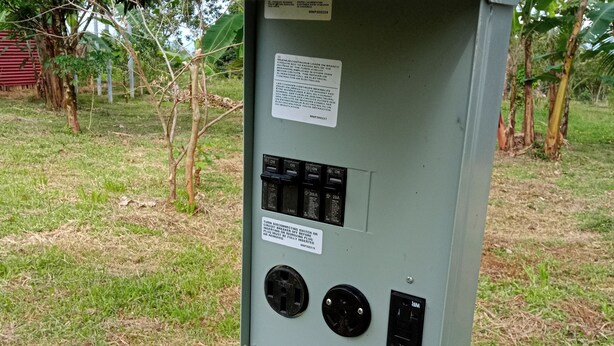 An electrical box with switches and a water tap.