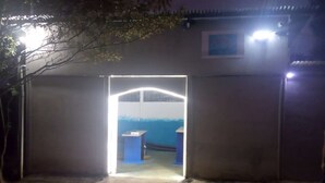 A doorway leading to a room with a blue and white color scheme, a small table, and a bench.