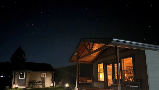 A house with a covered porch and a small garden area. - 4BR Ranch Retreat w/Hot Tub & Senic Valley Views + Mini House Add-On (Kamiah)