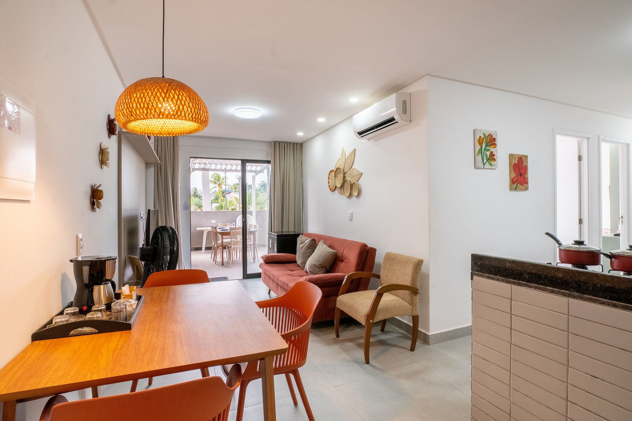 A modern kitchen with a dining area, a sofa, and a coffee machine.
