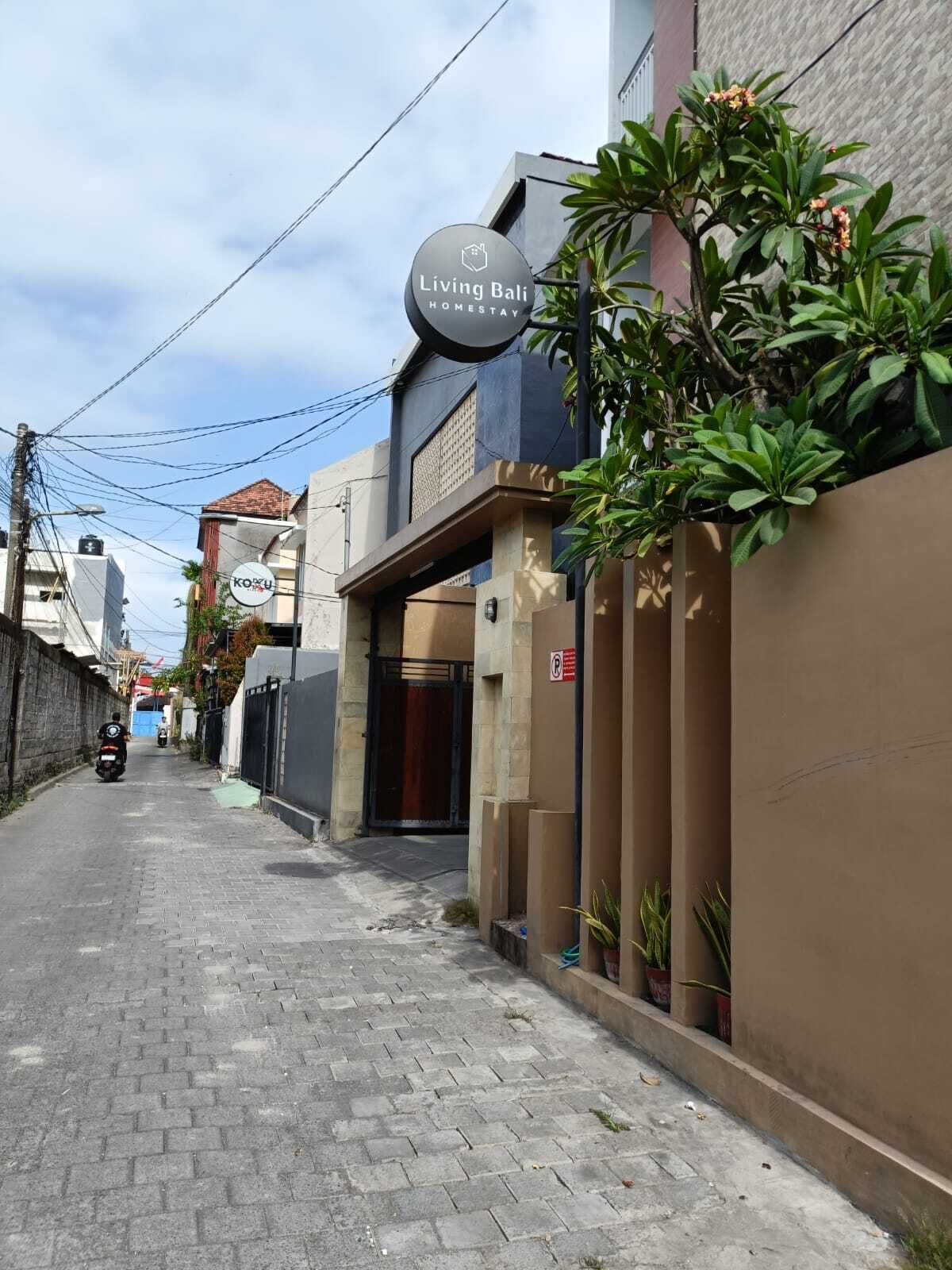 A residential building with a sign for 'Living Bali Homestay'.