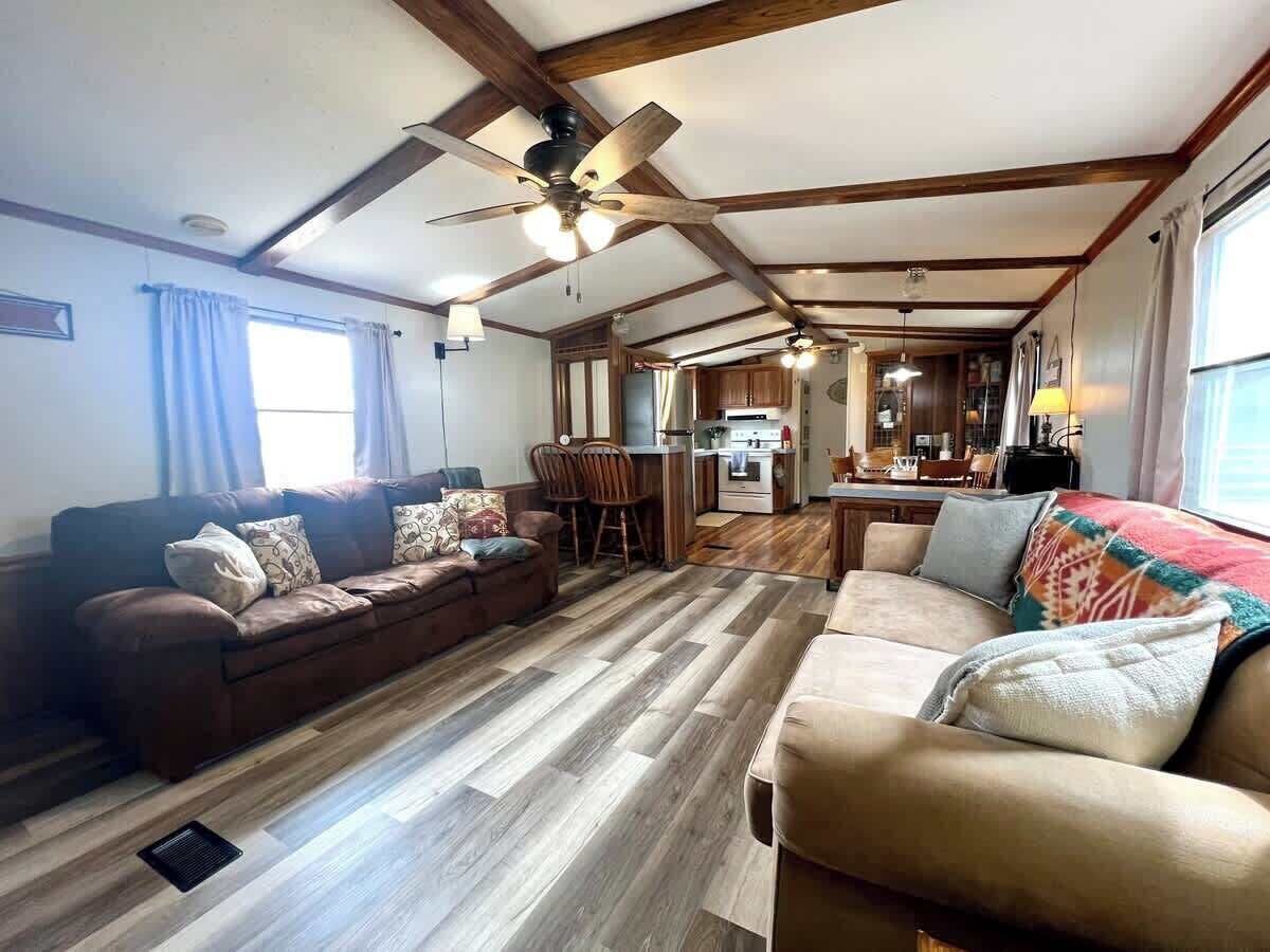 Living room and eat in kitchen , small eat at bar, and tv tray for extra people .