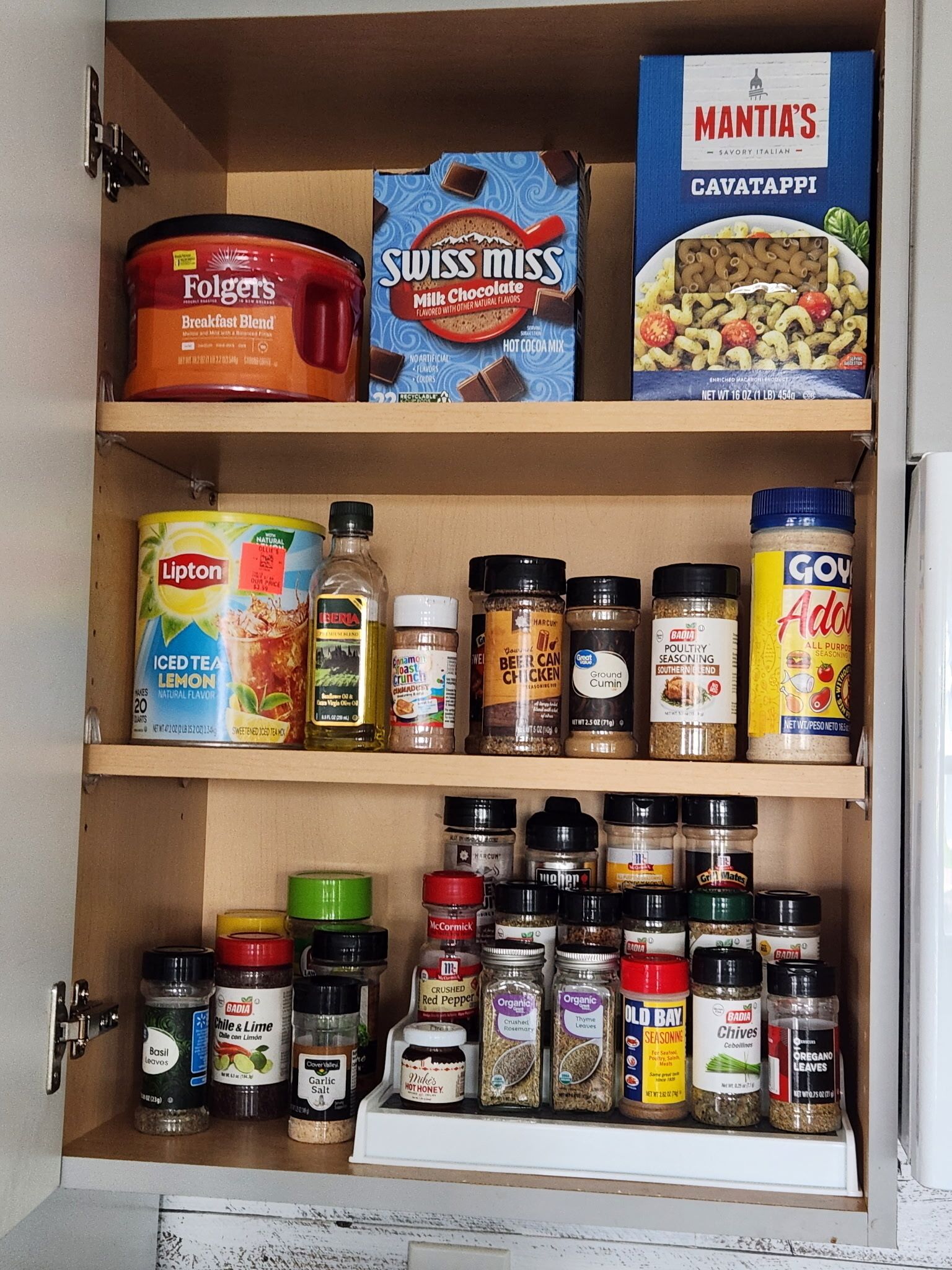 A pantry with various food items and condiments.