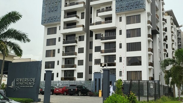 A multi-story residential building with balconies and a gated entrance. - Cozy Modern Studio Apartment in Ikoyi (Lagos)