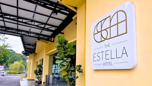 The exterior of The Estella Hotel with a clear entrance, a signboard, and potted plants. - The Estella Hotel Klang (Klang)