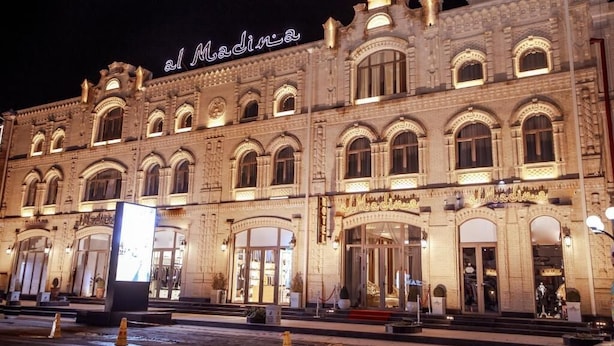 A historic building with arched windows and a prominent entrance. - al Madina Hotel Samarkand  (Samarkand)