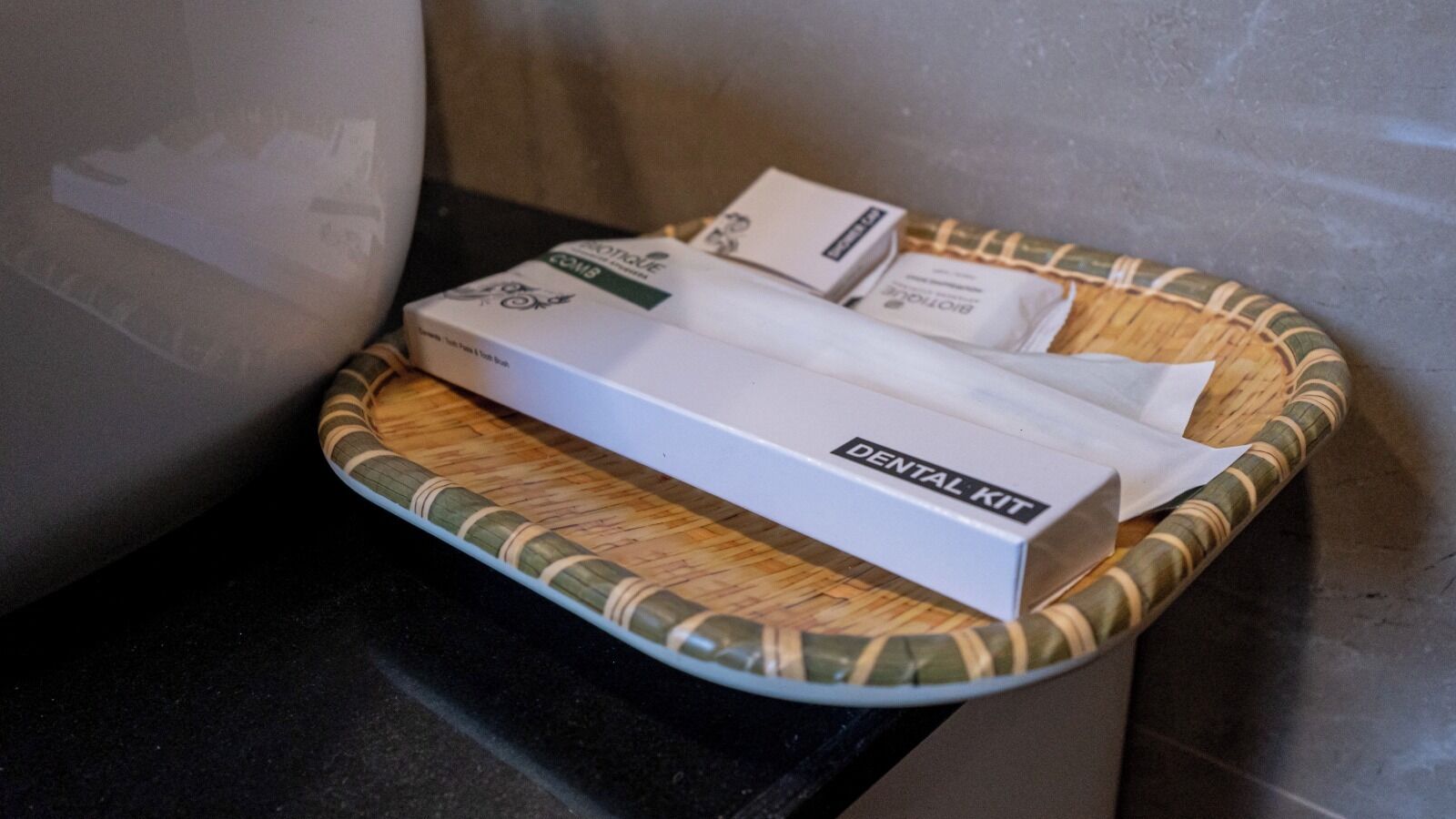 A dental kit in a basket on a countertop.