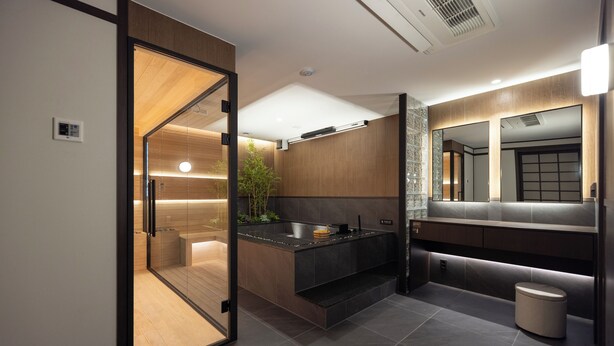 A modern bathroom with a glass shower enclosure, a built-in sink, and a vanity with a mirror. - Anook Ryokan Hotel Suwon (Suwon)