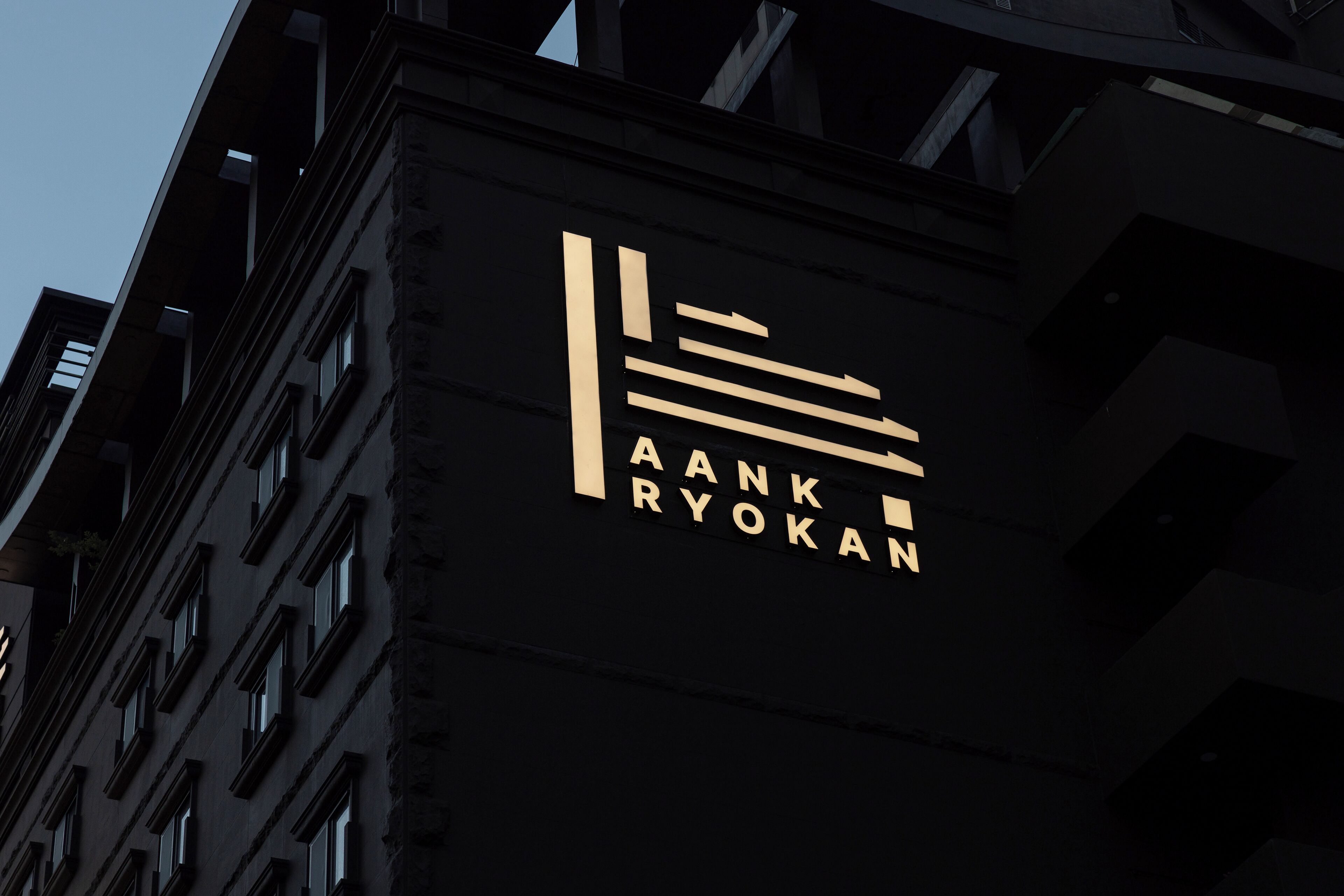 A building with a sign that reads "AANK RYOKAN".