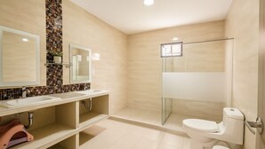 A modern bathroom with a large mirror, a sink, a toilet, and a shower area. - Charming 3-bedroom chalet, with private pool, an with AC. (Malambo)