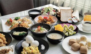 A variety of dishes on a table, including rice, eggs, and various salads. - ElEnce Hotel (Taichung)