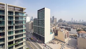 A high-rise building with multiple floors, large windows, and a modern architectural design. - Bloomfields Cozy 1Br Binghatti House  (Dubai)
