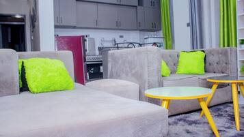 Apartment, Garden View | Living area | Flat-screen TV