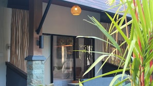 A modern building with a stone pillar, a staircase, and a glass door leading to a room. - The Kantun Ungasan (Ungasan)