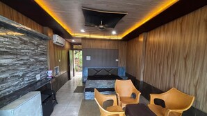 A spa area with a reception desk, seating area, and a massage table.
