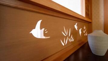 Un panneau en bois orné de motifs sculptés représentant des oiseaux et des plantes.