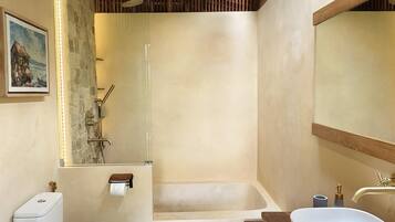 A bathroom with a wooden ceiling, a bathtub, a toilet, a sink, and a mirror.