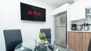 A modern kitchen with a built-in oven, a microwave, and a coffee maker.