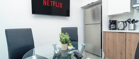 A modern kitchen with a built-in oven, a microwave, and a coffee maker.