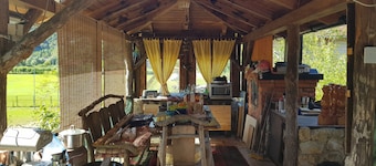 Bosnian house next to the Una river, with a view of the old Ostrovica fortress