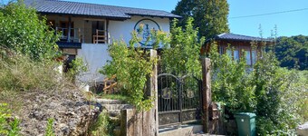 Bosnian house next to the Una river, with a view of the old Ostrovica fortress