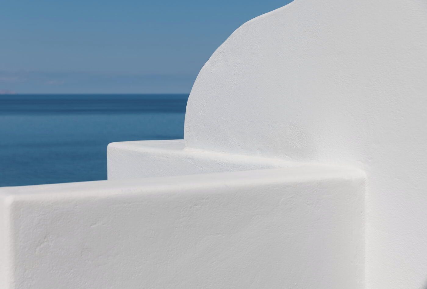 A white architectural feature with a curved edge, likely part of a building or structure.