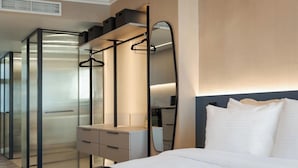 A modern hotel room with a large bed, a walk-in closet, and a large mirror. - Athena Suite by Acropolis Luxury Athens Suites (Athens)