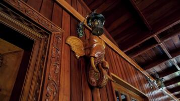A wooden interior with carved wooden panels and a decorative lantern.