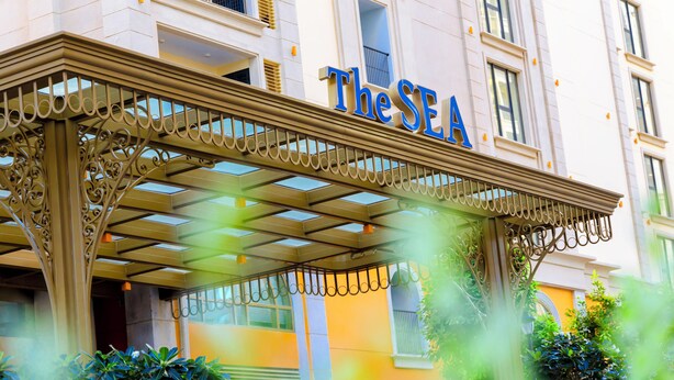 A hotel entrance with a sign reading "The SEA". - Mira Home Apartment Hillside Phu Quoc (Phu Quoc)