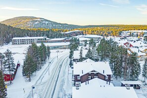 A snow-covered town with a prominent building labeled 'Water World Levi' and a ski lift in the foreground.