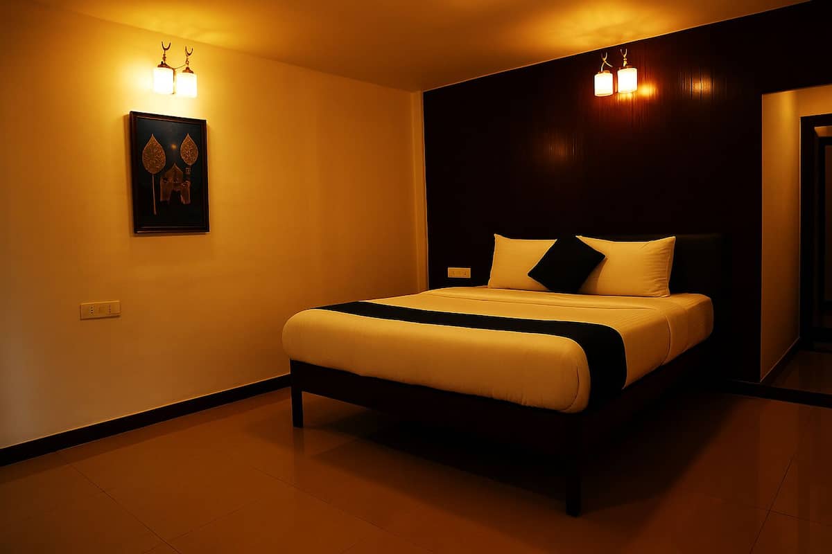 A modern hotel room with a large bed, dark wood paneling, and wall-mounted lighting.