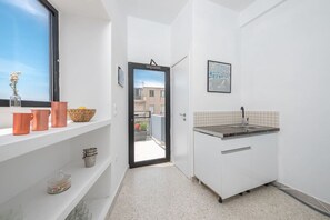 Coffee/tea maker, toaster, cookware/dishes/utensils, dining tables