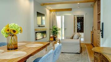 Suite, City View | Living area | 65-inch Smart TV with cable channels, fireplace