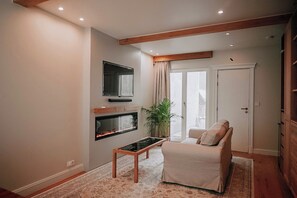 Suite, City View | Living area | 65-inch Smart TV with cable channels, fireplace - The Lovelace Residence (Bruges)