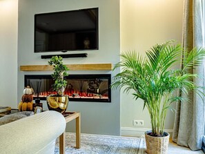 스위트, 시내 전망 | 거실 공간 | 케이블 채널 시청이 가능한 65인치 스마트 TV, 벽난로