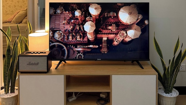 A television on a wooden TV stand with a mirror above it. - Welcome to Casa Sheridan Your Cozy Escape in the Heart of the Metro 🌿 Whet (Pasig)
